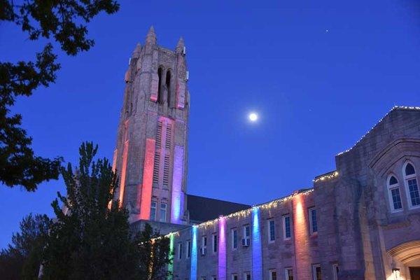 At night with colored lights.