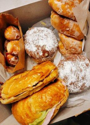 Assorted donut holes, Bavarian donut with Nutella cream, glazed donut, bacon croissant, ham croissant.