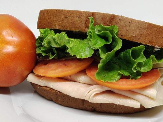 Ham, swiss cheese, sliced tomato, and fresh green leaf lettuce. Topped with Mustard Mayo and served on sourdough bread.