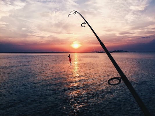 Sunset, fishing, Boston on the right.