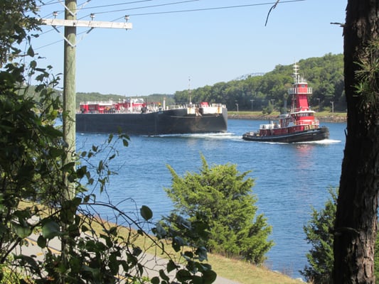 Tug pulling barge on canal