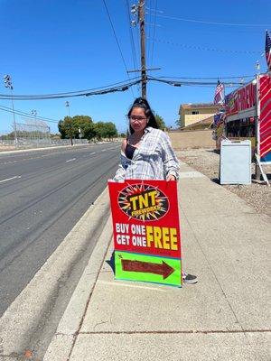 Youth member holding up a sign to promote.