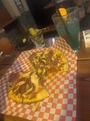 Delicious pizza and blue Hawaiian mixed drink