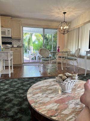 Sofa area into breakfast nook and kitchen. View of private terrace.