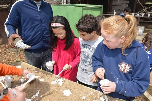 Kids learn how to make fossil casts of dinosaur foot prints at the CSTL summer camp.