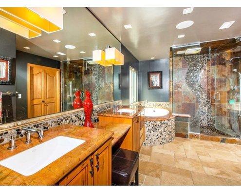 Master bathroom with steam shower, travertine floors, "Iron Ore" paint color by Sherwin Williams