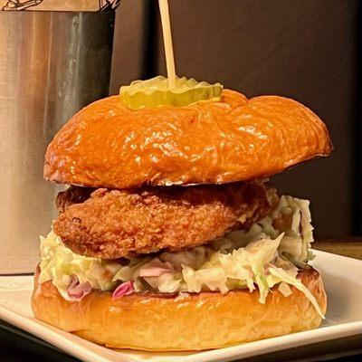 Crispy breast of chicken with savory sauce, pickles, homemade slaw on the brioche bun. 
 Need a little more heat order it tossed in buffalo