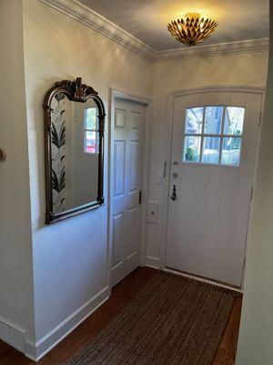 Entry used to be closed off with an extra door. We opened it up and created an entry closet with a pocket door.