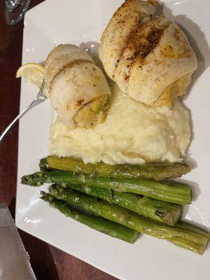 Stuffed flounder with crab meat stuffing , mashed potatoes and asparagus