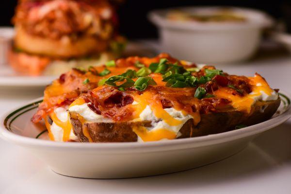 Signature Baked Potato with scallions, bacon, sour cream and cheddar