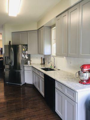 Kitchen cabinet installation, with plumbing for kitchen sink.