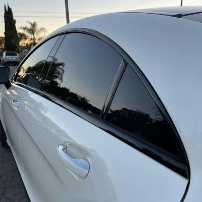 CLS63s AMG Roof, roof rails, and window trims done in Avery Gloss Black