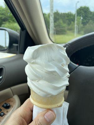 Soft serve vanilla cone that is already being enjoyed