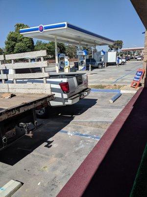 A truck parked in the blue line cross-hatched space where the ramp is.