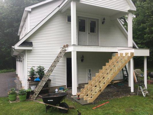 This garage area was unfinished for years. We trimmed the pillars, ceiling, and added a staircase.