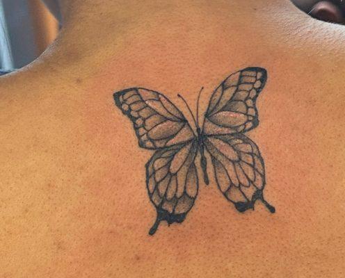 Butterfly tattoo with white highlights