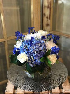 Blue delphinium, roses and hydrangea