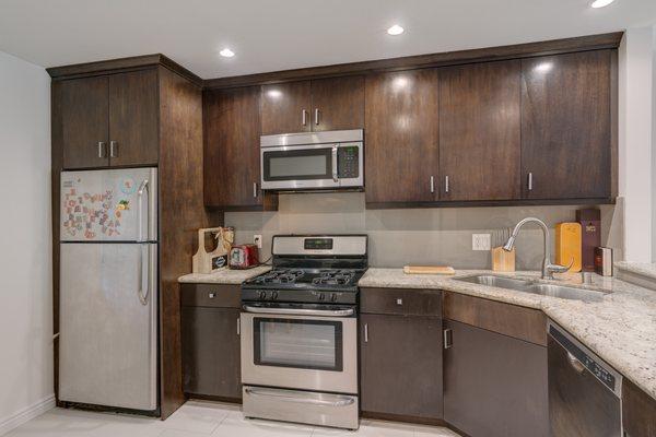 The Kitchens at The Roscomare include Custom Cabinets, Stone Counters, LED Lighting and Stainless Steel Appliances