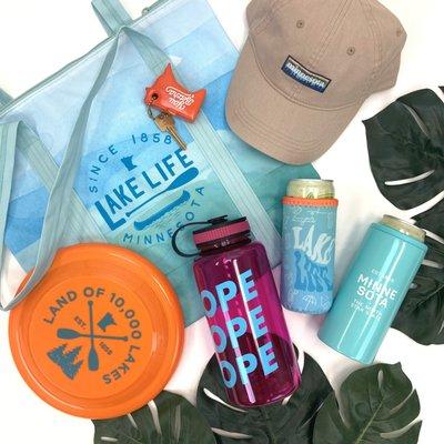 Gift items like bags, hats, water bottles, and can coolers at 218.