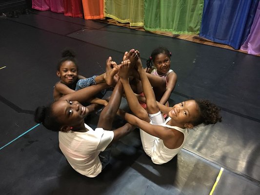 Children learn multiple dance styles in a multi-media athletic dance environment.