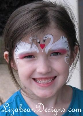 Swan face painting at a birthday party.