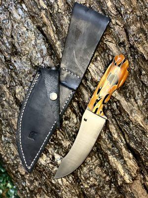 Modified trailing point field knife. Blued blade for corrosion resistance with synthetic handle.