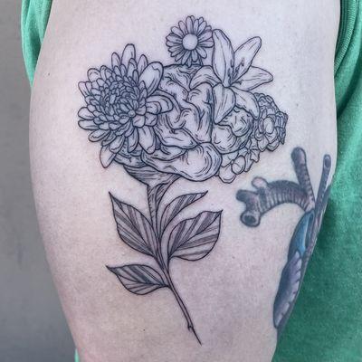 Fine line flower bouquet with brain tattoo on an arm