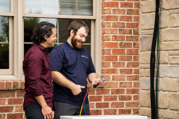 Shipley Energy's HVAC Technician, Derek, explaining the AC Tune Up process to a homeowner