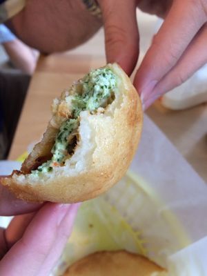 pollo mechada empanada with the green sauce