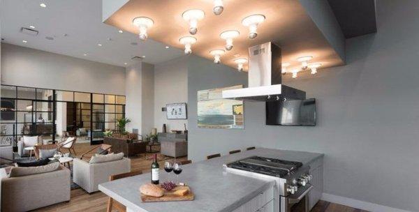 The lounge at The Paramount offers residents a graceful kitchen and seating arrangement.