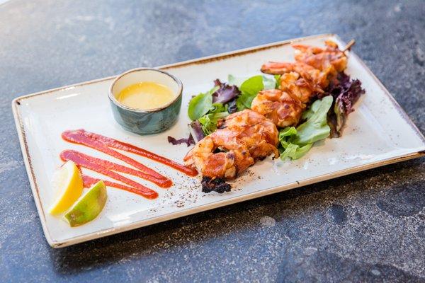 Applewood Smoked Bacon wrapped Barbeque Shrimp Skewer.  Served with a red pepper mango chutney