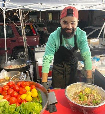 Owner Recep showcasing his fresh vegetables and ezme salad