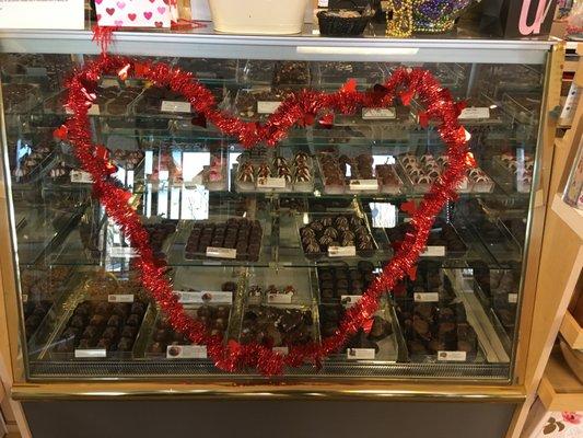 The candy counter by registers with lots of chocolate!