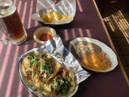 Tacos Al pastor, rice and beans, chips and salsa and Dos Equis