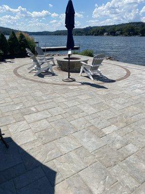 Lakeside paver patio with wood firepit