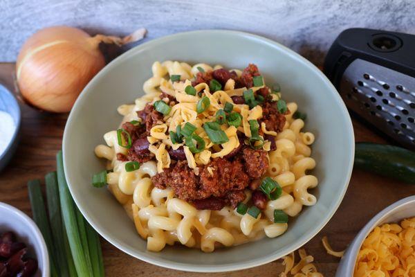 Our Chili Mac. Spiced beef and bean chili mixed with our bold cheddar sauce and topped with more shredded cheddar and green onions.