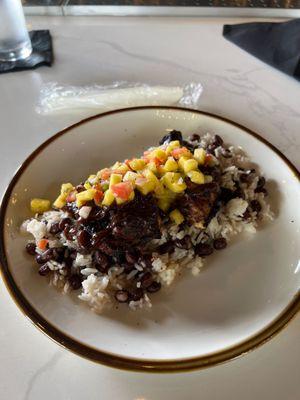 Jerk Chicken Quarter with coconut rice and beans.