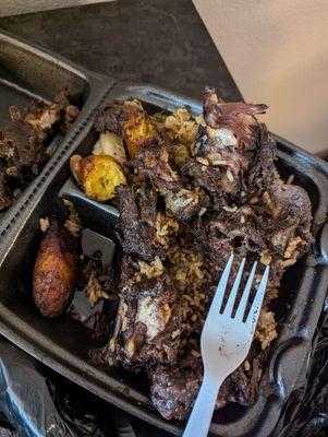 Oxtails bedded on rice +peas, sides: cabbage and candied plantain. Good. Served nice + hot.