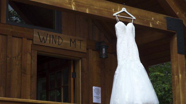 A wedding dress hands from a cabin.