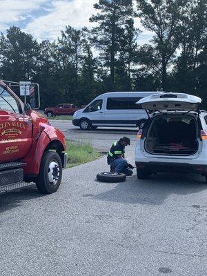 The awesome Cliff changing my tire in the median of I-95.