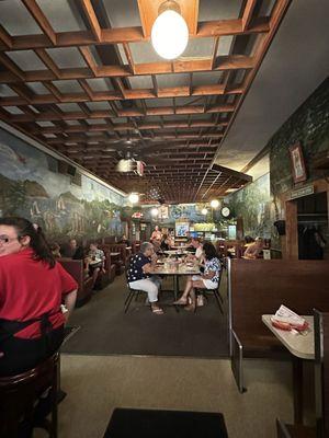 Center dining room and bar.   look at then ceiling and walls.