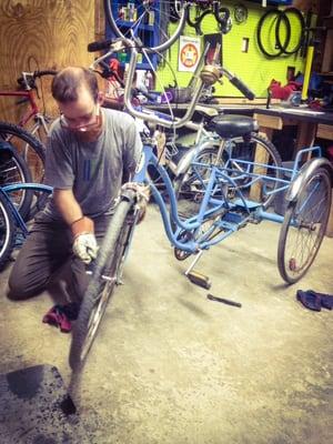 One of the volunteers cleaning up a trike