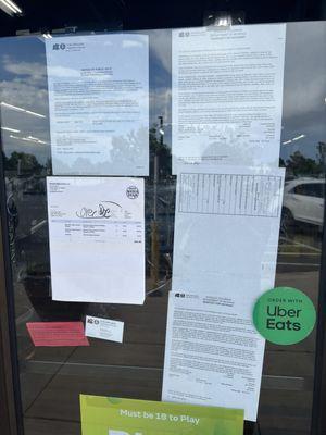 Documents in the window explaining the seizure of this place by the state for nonpayment of taxes