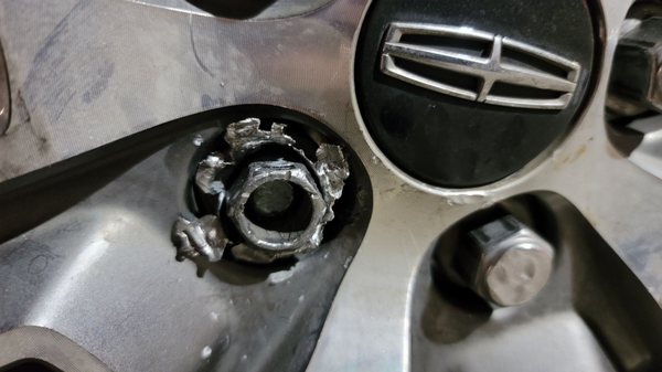 A stripped lug nut added insult to injury while attempting to change a roadside flat.