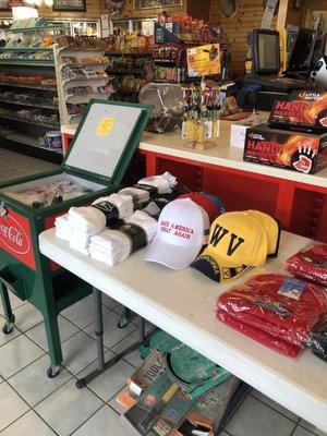 Vintage Coca Cola cooler full of iced cokes and several Baseball caps