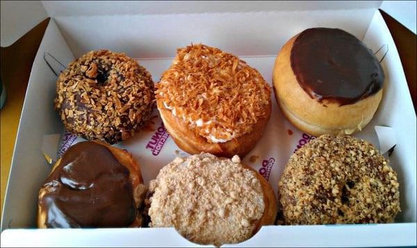 Clockwise from upper left: German Chocolate, Toasted Coconut Creme, Boston Creme, Peanut, Blueberry Crumb, Chocolate P.B. Cup.