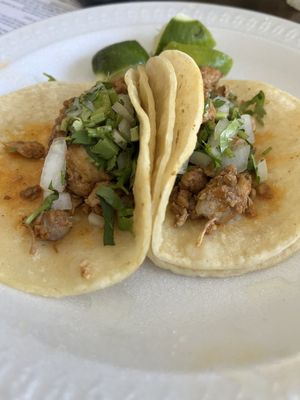 Pollo taco and pastor taco on corn tortillas