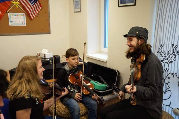 Kyle teaches kids fiddle in the Czech Republic