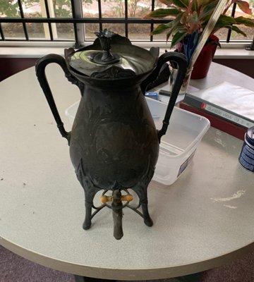 Large urn with bent lid.