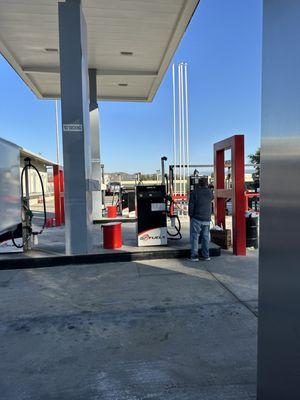 Guy standing in front of tiny kiosk where you pay